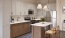 a kitchen with white cabinets and wooden accents