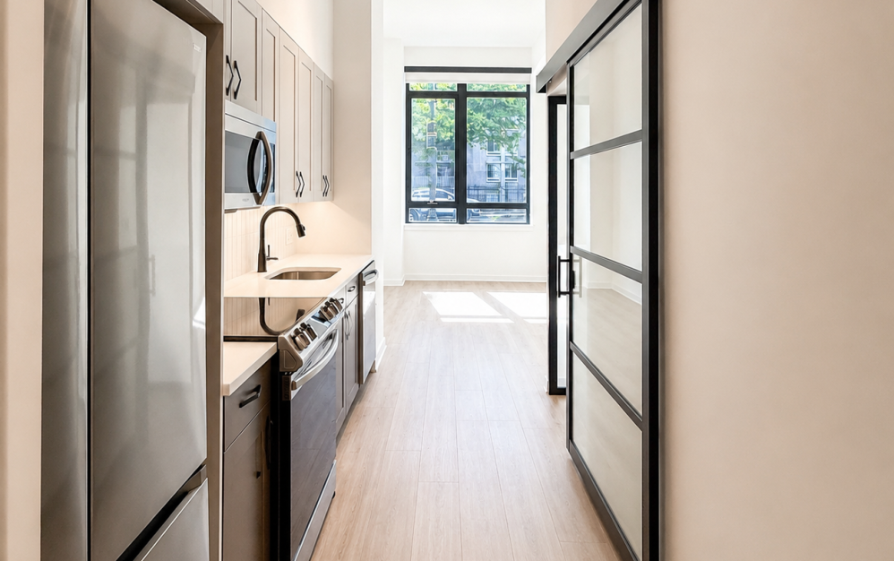 Professionally staged living room in the A1 apartment at The Iris NoMa featuring high ceilings, modern finishes, luxury furnishings, oversized windows, and an open-concept layout in Washington, DC.
