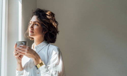 a woman holding her mug of coffee