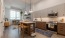 a kitchen with white cabinets and wooden accents