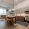 Model kitchen at our apartments for rent in Washington DC, featuring wood grain floor paneling and a kitchen island.