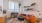 Model living room at our apartments for rent in Washington DC, featuring wood grain floor paneling and couch