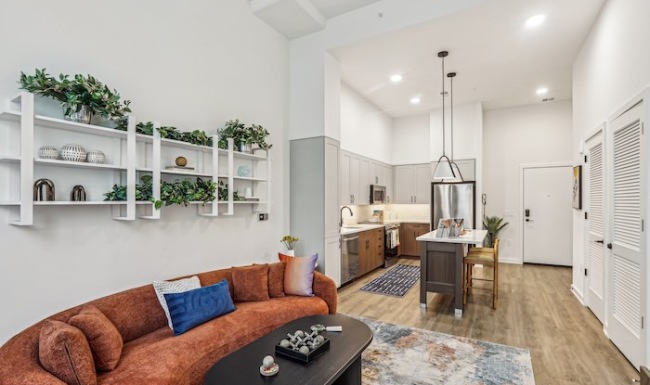 Large couch in living room and bar stools at island Open concept living room and kitchen